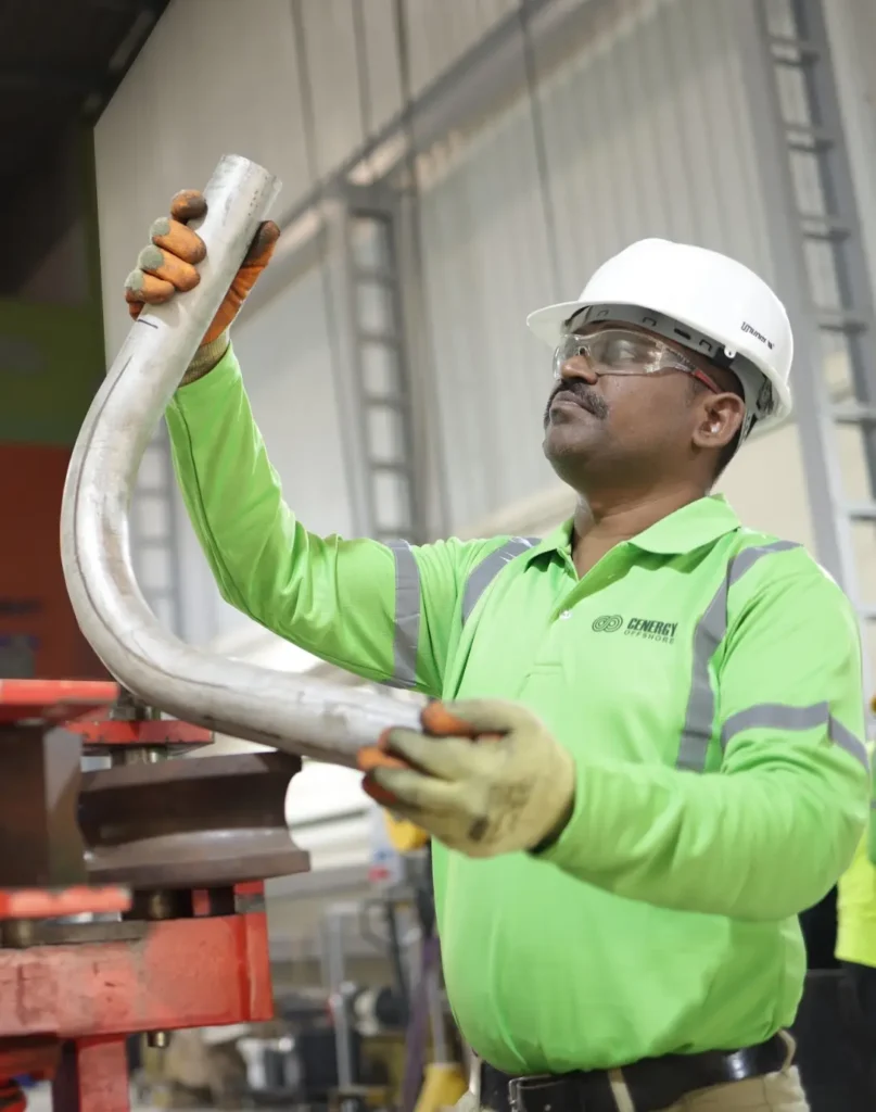 Cenergy Offshore Personnel inspecting pipe after bending